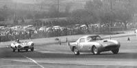 Thumbnail: view across a sweeping turn at Pomona, D-type Jag and 250GT visible