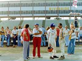 Thumbnail: A.J. Foyt and George Follmer at an IROC. The 70s clothing on the standers-around is amazing.