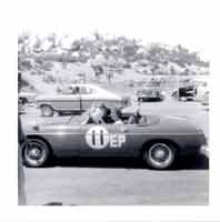 Thumbnail: Sandy at the wheel of the MGB Tourers in the tech line at Tecate, Baja California, Mexico landing strip