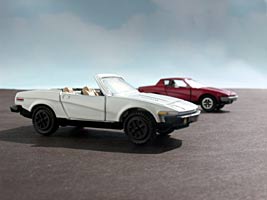 Photo: White TR7 convertible with an original Dinky coupe in the background. CLICK to see a larger version.